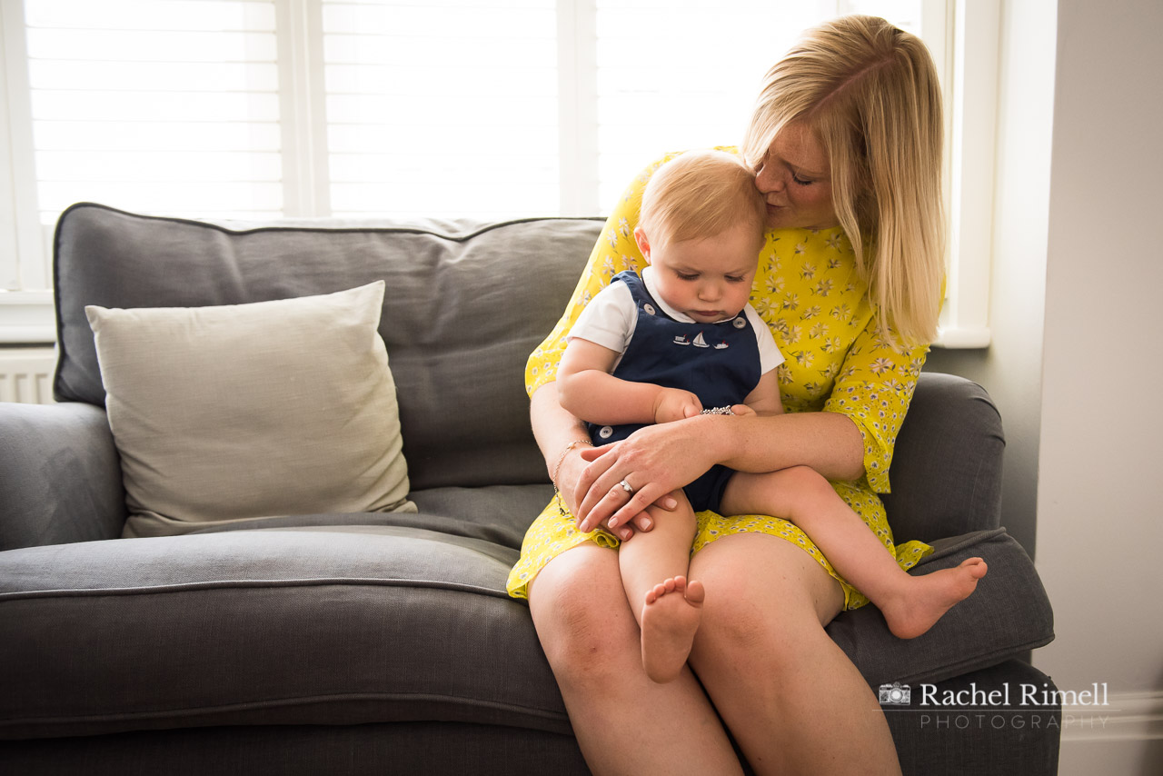 Mother kissing top of toddler son's head Tooting