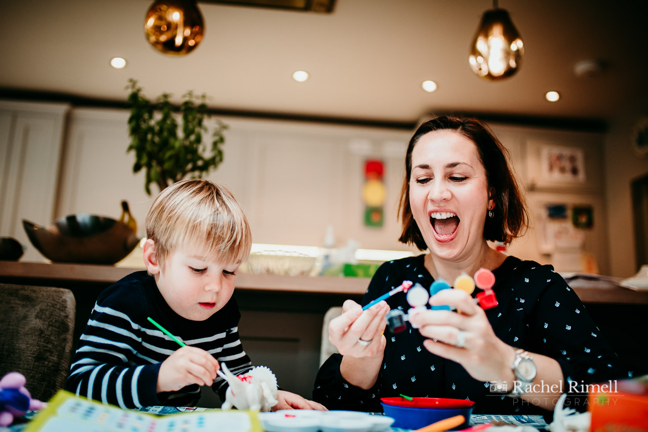 Mother and son laughing as they paint crafts. natural photo Clapham 