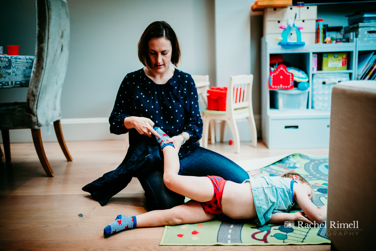 documentary family photo session Clapham - mother dresses child