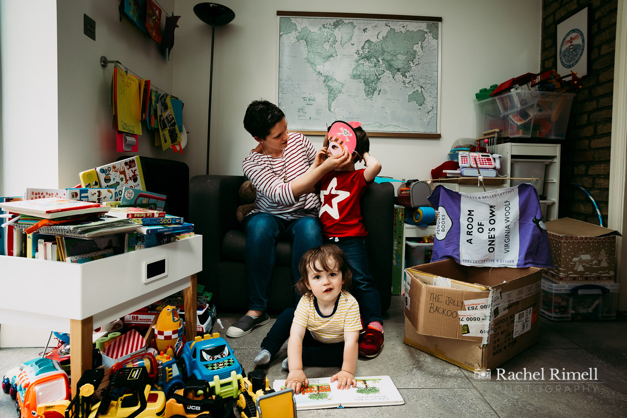 Mother plays with her sons at home in London environmental portrait