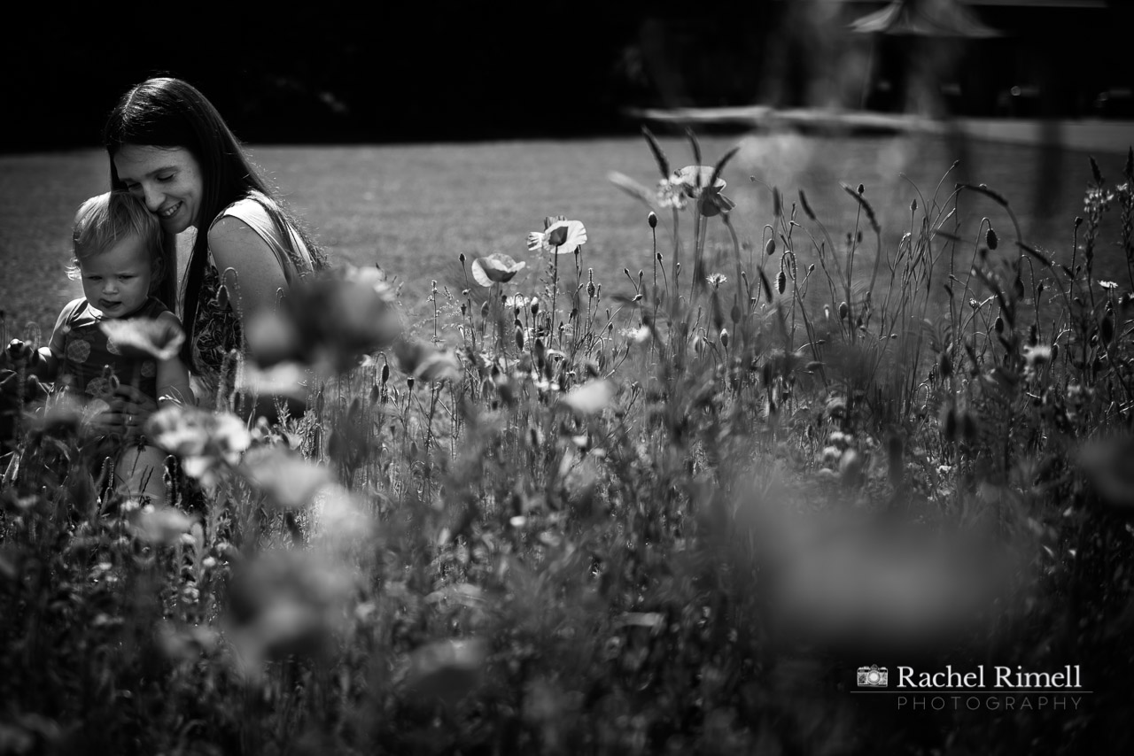 Mother sits with her daughter in the poppies Hall Place Bexley 