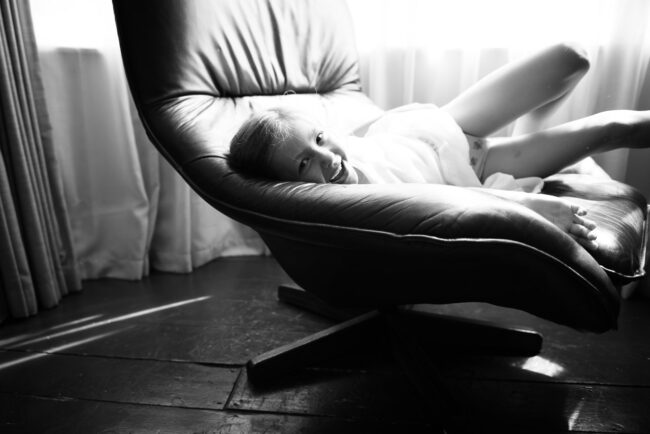 candid portrait of girl on swivel chair with window in background. Forest Hill. London