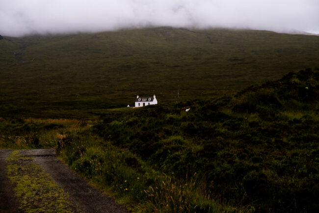 fine art photography print - white bothy in the green hills with mist overhead