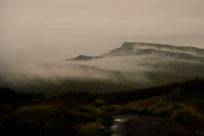 fine art landscape photography print - mist lying in layers across the hills with heather in foreground at Old Man of Storr in Skye