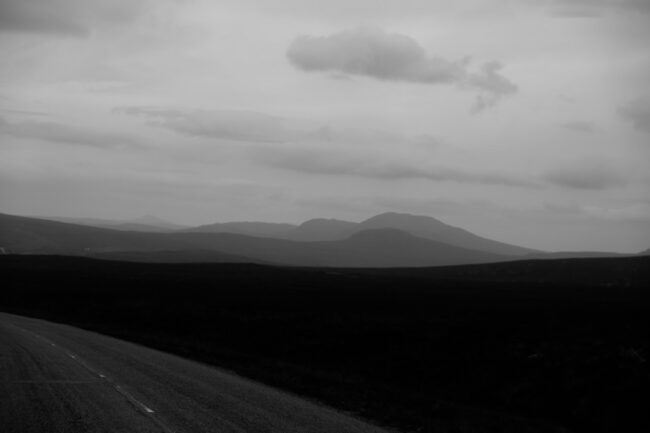 fine art landscape photography print - road in forground with hills in the background in black and white
