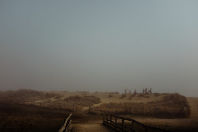 fine art landscape photography print - mist over Walberswick with silhouette of people on the dunes