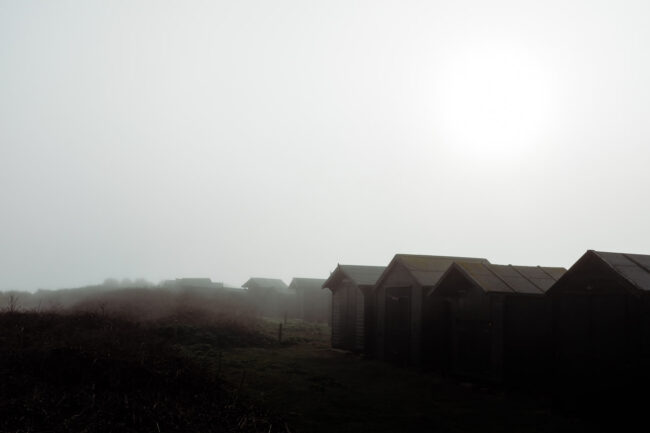 fine art photography prints - seascape of beach huts in the mist in black and white