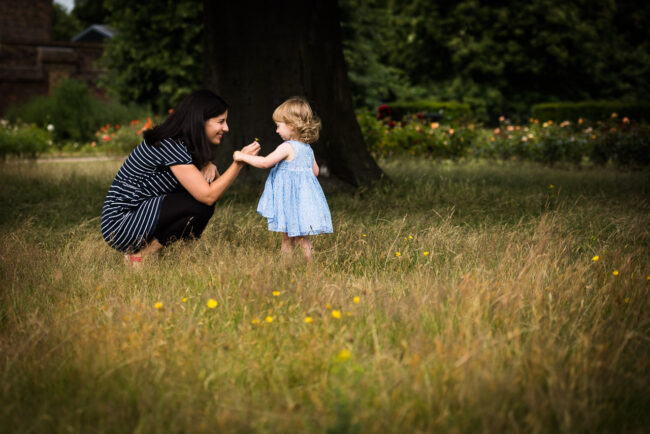 Mother and daughter in field of buttercups, unconventional natural family photography London