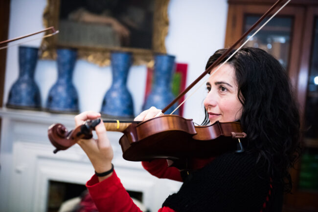 Musician with violin at Blackheath Conservatoire for an editorial photography session, London