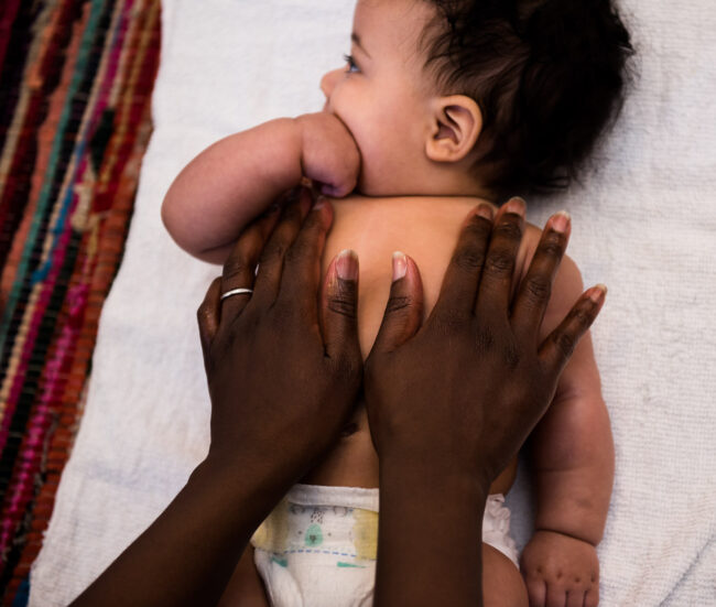 baby being massaged by mums hands at a baby massage class in Streatham London