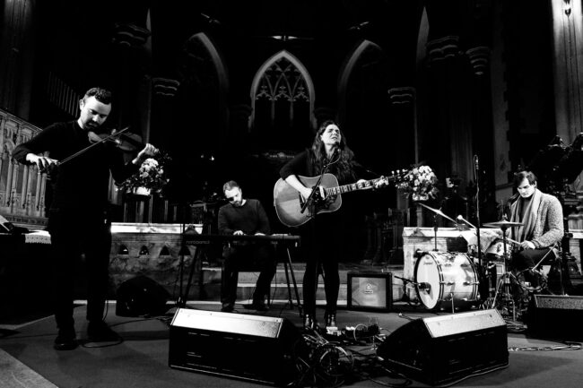 black and white events photo of Michele Stodart of The Magic Numbers and her band performing at Sydenham arts in St Bartholomew's Church
