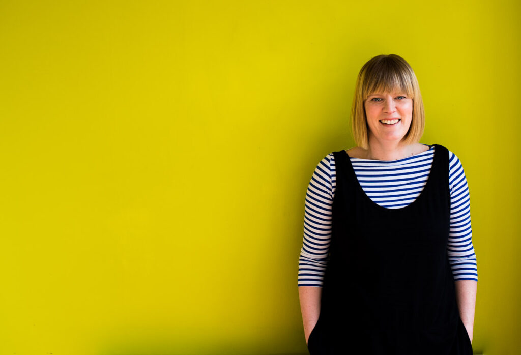 Natural headshot of Janine Green Coach against lime green background, London