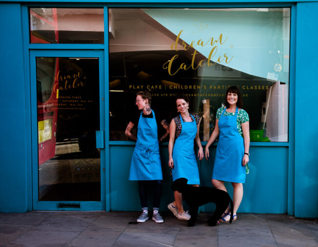 fun personal branding photo of small business owner and staff outside Dreamcatcher cafe in Crystal Palace, London