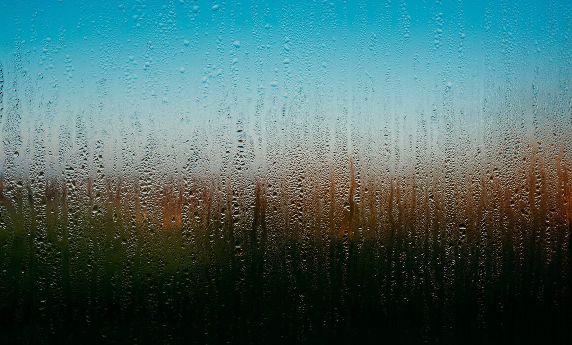 fine art photography condensation on a window with abstract colours behind