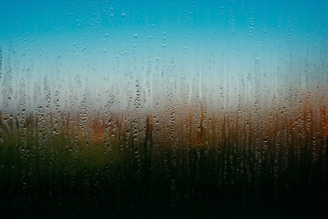 fine art photography condensation on a window with abstract colours behind