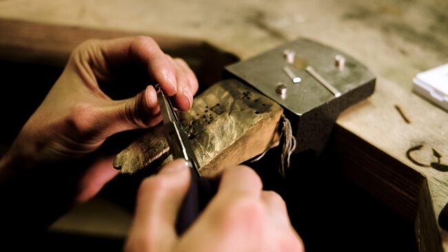 detail of working on some jewellery fitting with pliers in Crystal Palace London from a branding photography session