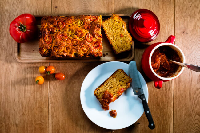 style food photo of tomato bread with tomato chutney on a wooden board