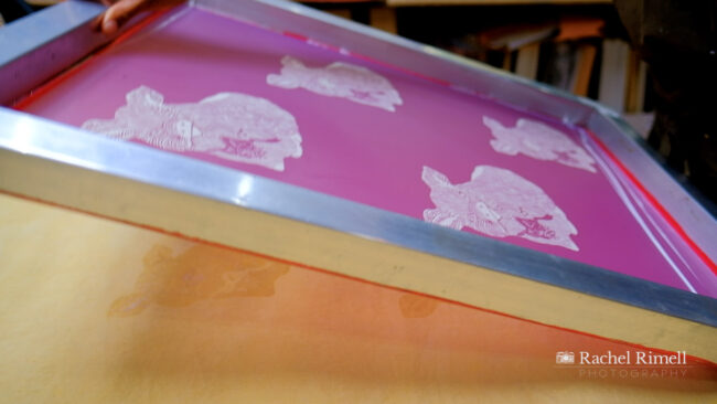 detail of screen print being lifted off fabric by textile artist