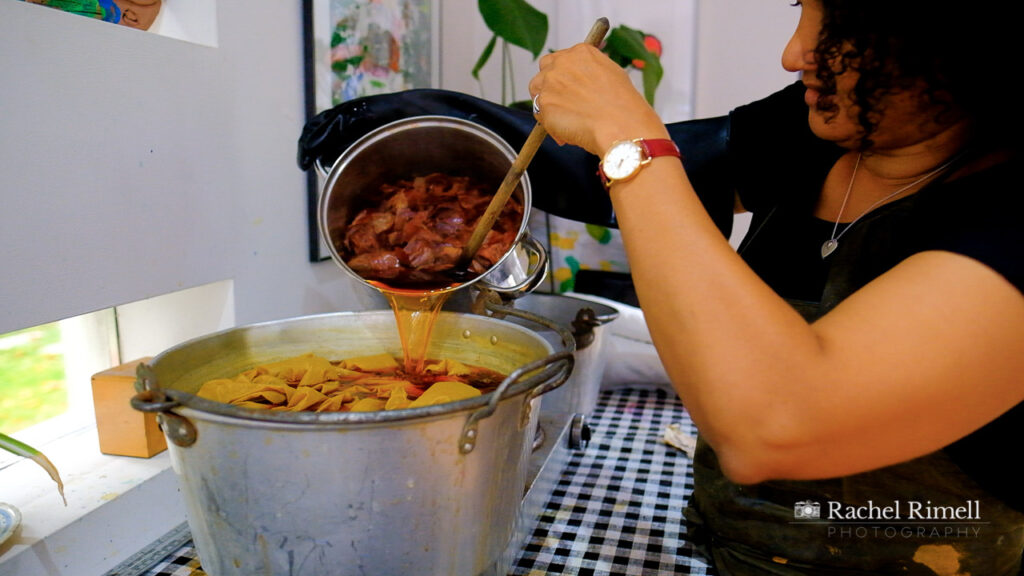 London textile artist in her studio pouring onion skin natural dye into dying pot