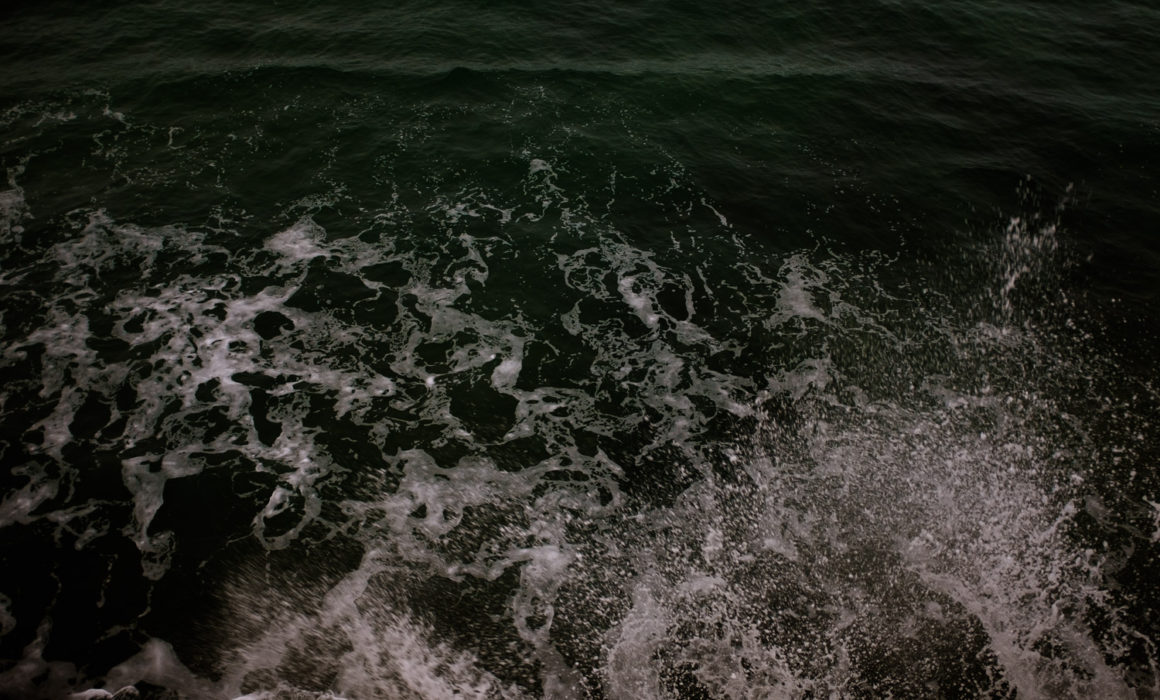 Big smash as a wave hits the sea wall with spray