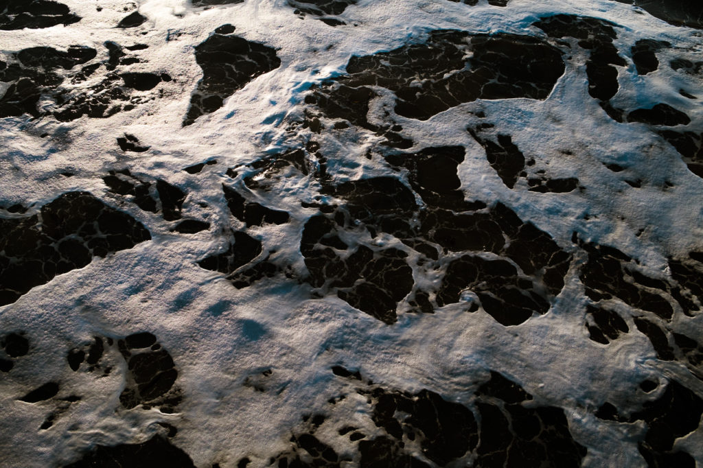 close up of the sea at Whitby beach North Yorkshire, white foam on the blue water