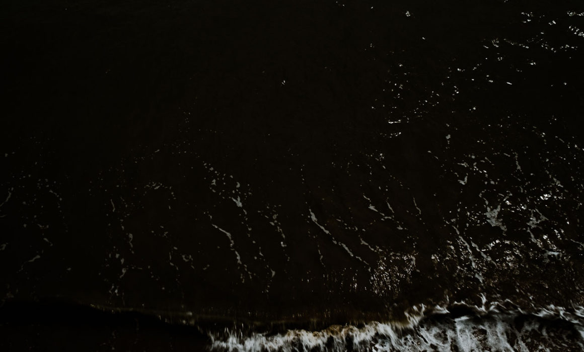 Sea spray splashing against the wall in Filey, North Yorkshire