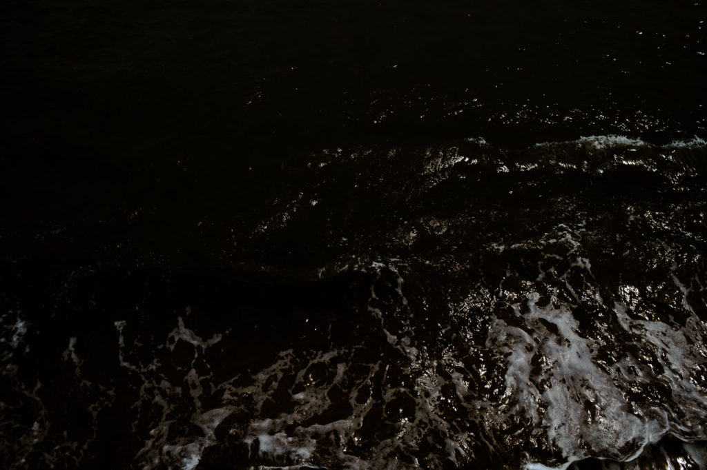 Overhead view of the sea splashing against the sea wall in Filey North Yorkshire