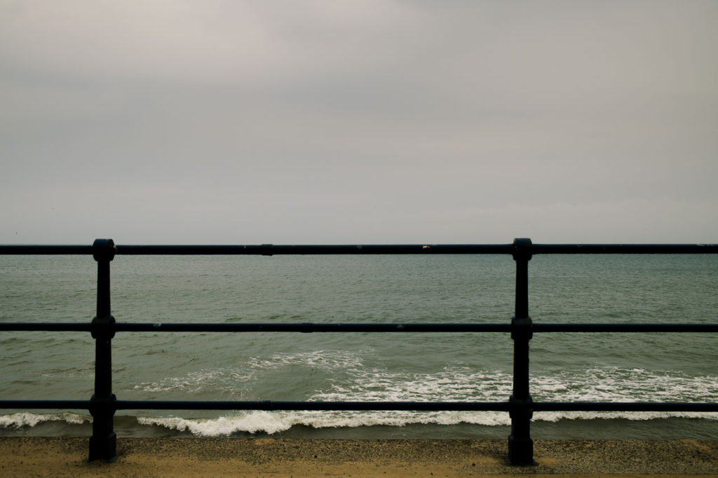 railings on the sea front at Filey in the rain