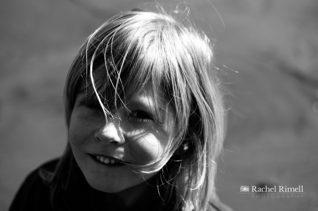 Natural black and white portrait of a child on Whitby beach