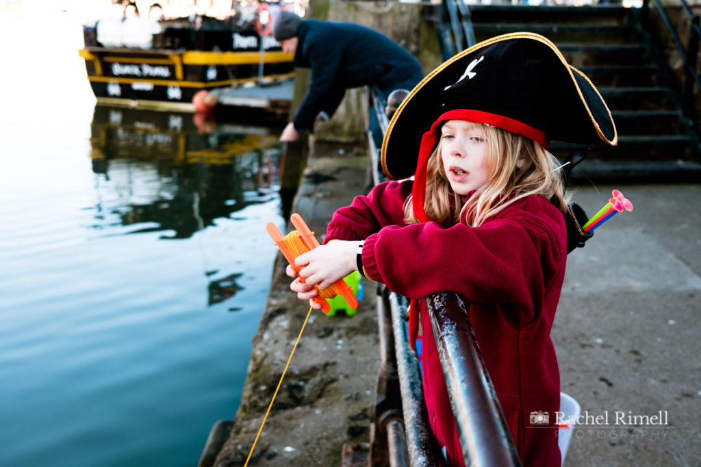 Girl dressed as a pirate crab catching off Whitby pier