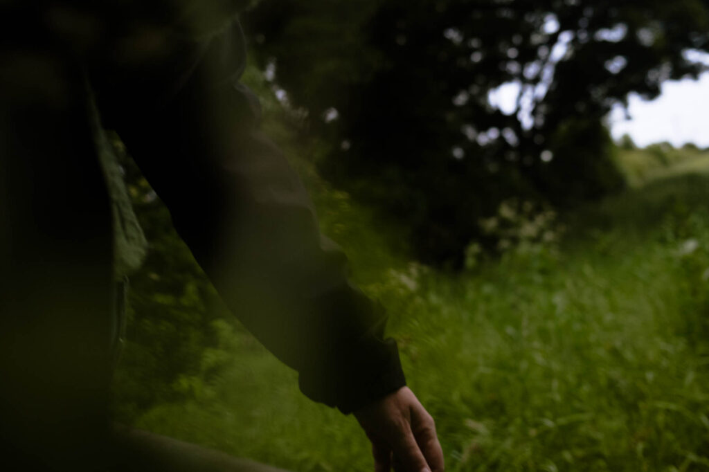 Photographic work exploring trespass and right to roam North Yorkshire. image of an arm against hazy woodland backdrop