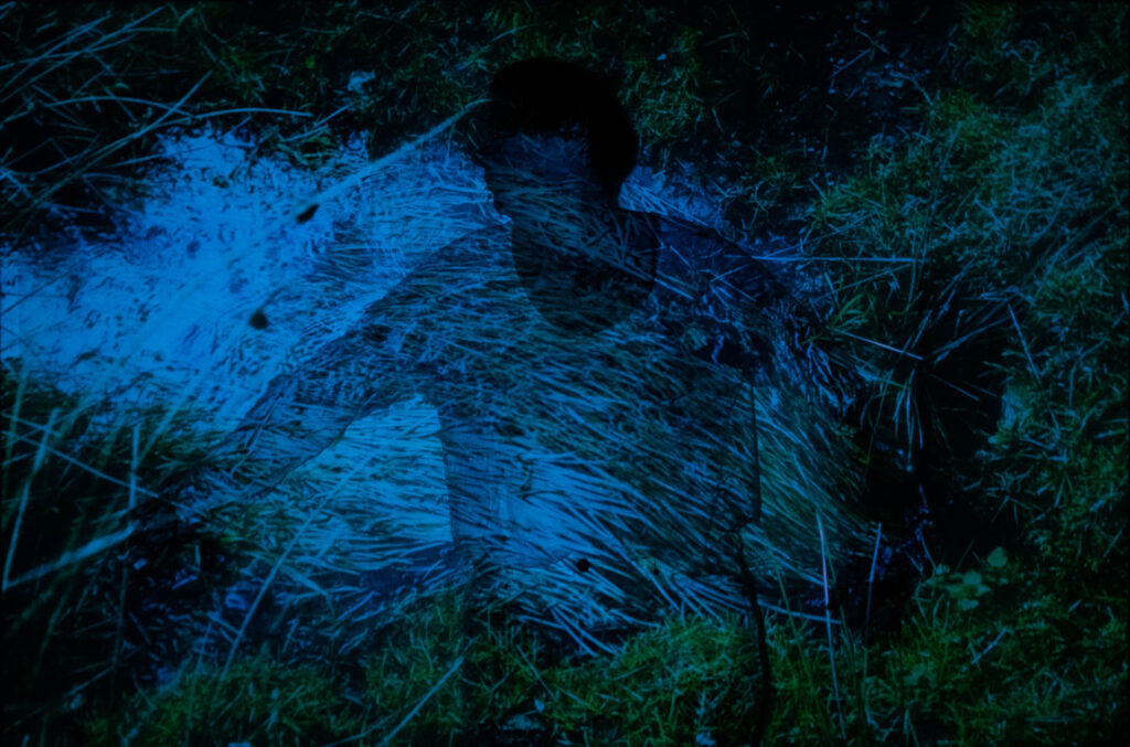 Photographic work exploring trespass and right to roam North Yorkshire. image of water and grasses in unnatural colours projected onto the figure of a woman in white