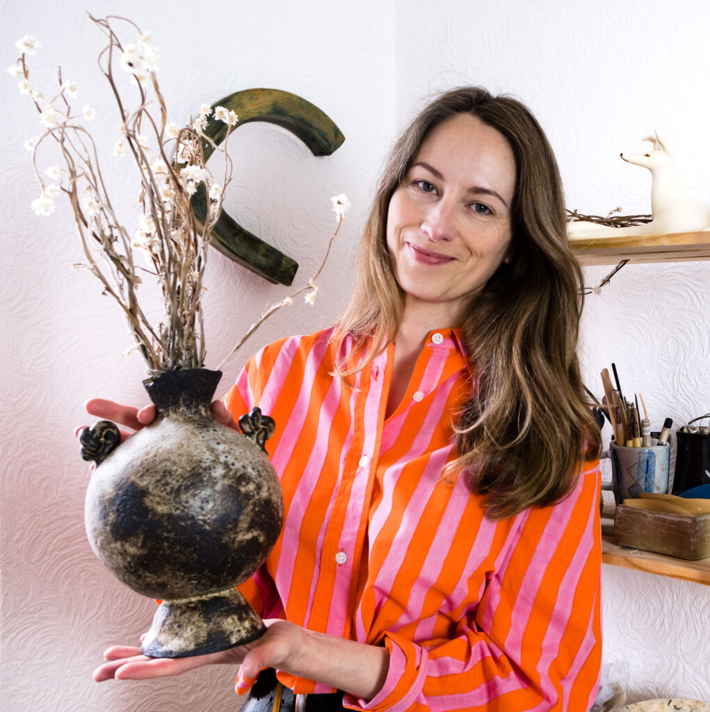 artist headshot woman holding vase